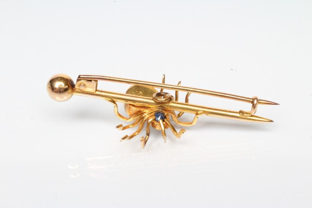 AN EDWARDIAN SPIDER BROOCH with oval facet cut sapphire head and blister pearl body on arrow head Image