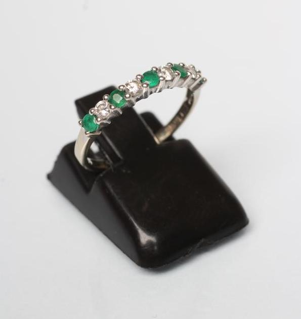 AN EMERALD AND DIAMOND HALF HOOP ETERNITY RING Image
