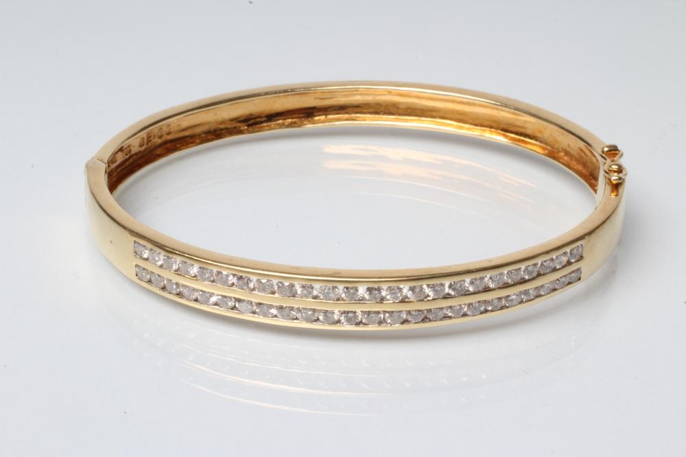 A DIAMOND STIFF HINGED BANGLE Image