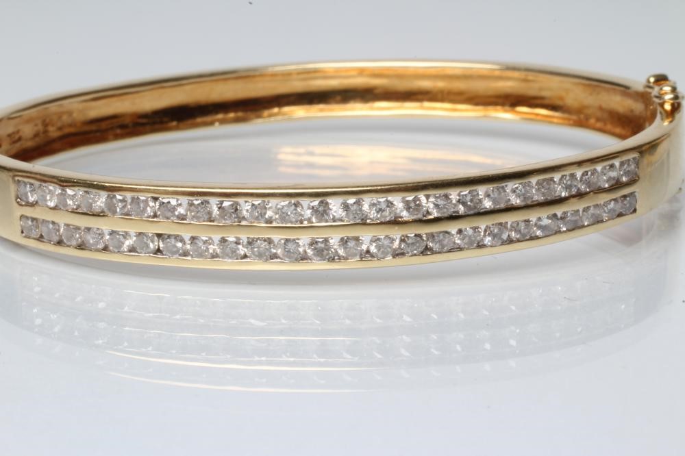 A DIAMOND STIFF HINGED BANGLE Image