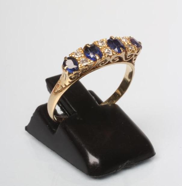 A SAPPHIRE AND DIAMOND HALF HOOP RING Image