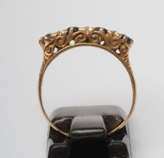 A SAPPHIRE AND DIAMOND HALF HOOP RING Image