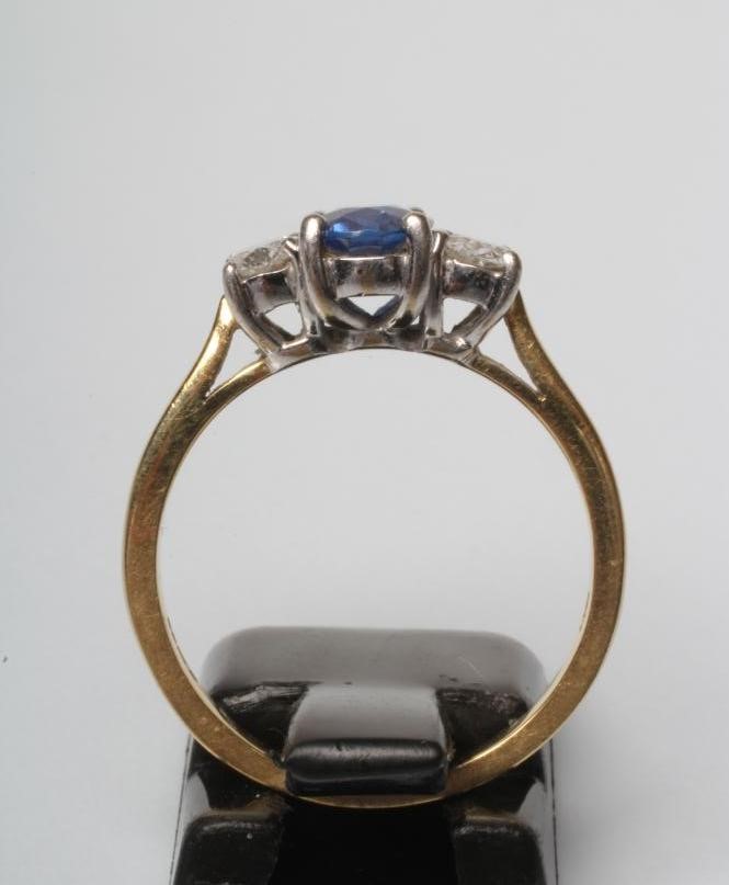 A SAPPHIRE AND DIAMOND THREE STONE RING Image