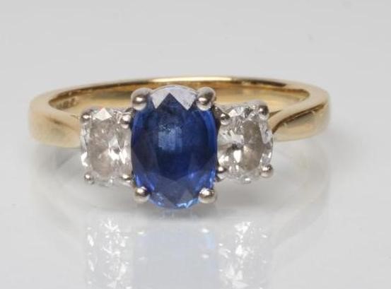 A SAPPHIRE AND DIAMOND THREE STONE RING Image