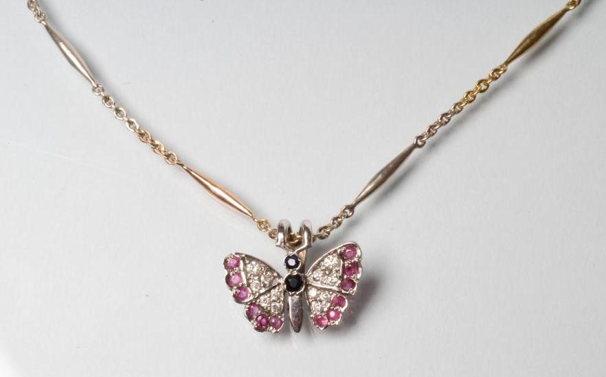 A BUTTERFLY PENDANT with diamond and ruby set wings and sapphire body Image