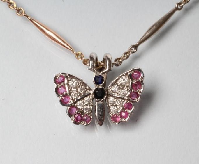 A BUTTERFLY PENDANT with diamond and ruby set wings and sapphire body Image