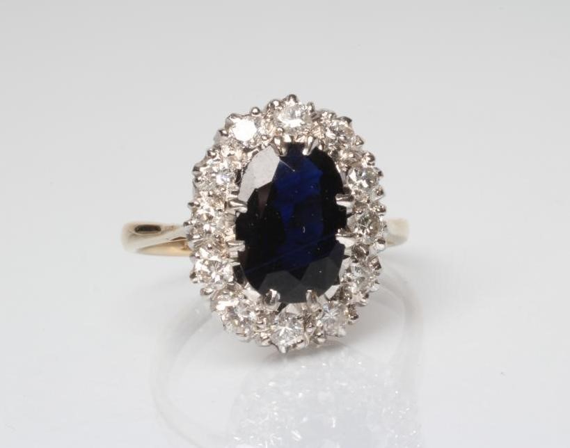 A SAPPHIRE AND DIAMOND CLUSTER RING Image