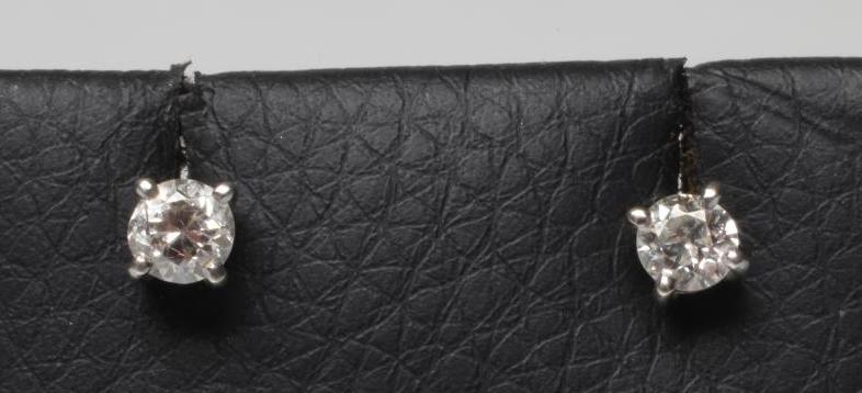 A PAIR OF SOLITAIRE DIAMOND STUD EARRINGS Image