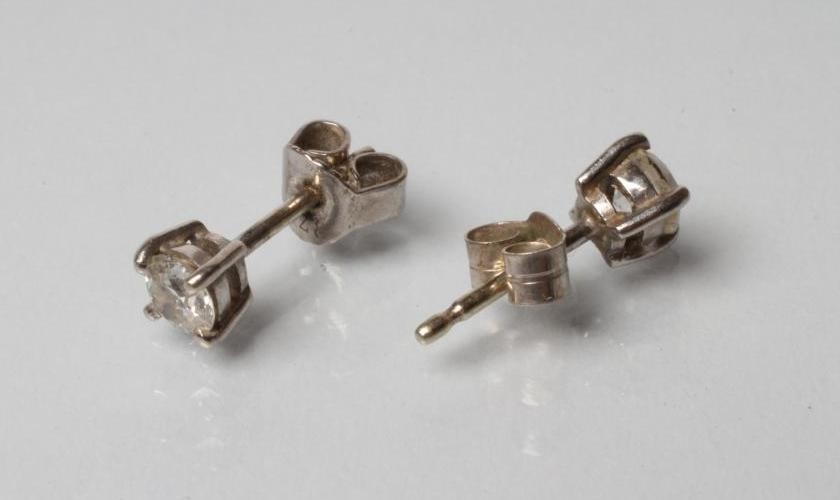 A PAIR OF SOLITAIRE DIAMOND STUD EARRINGS Image