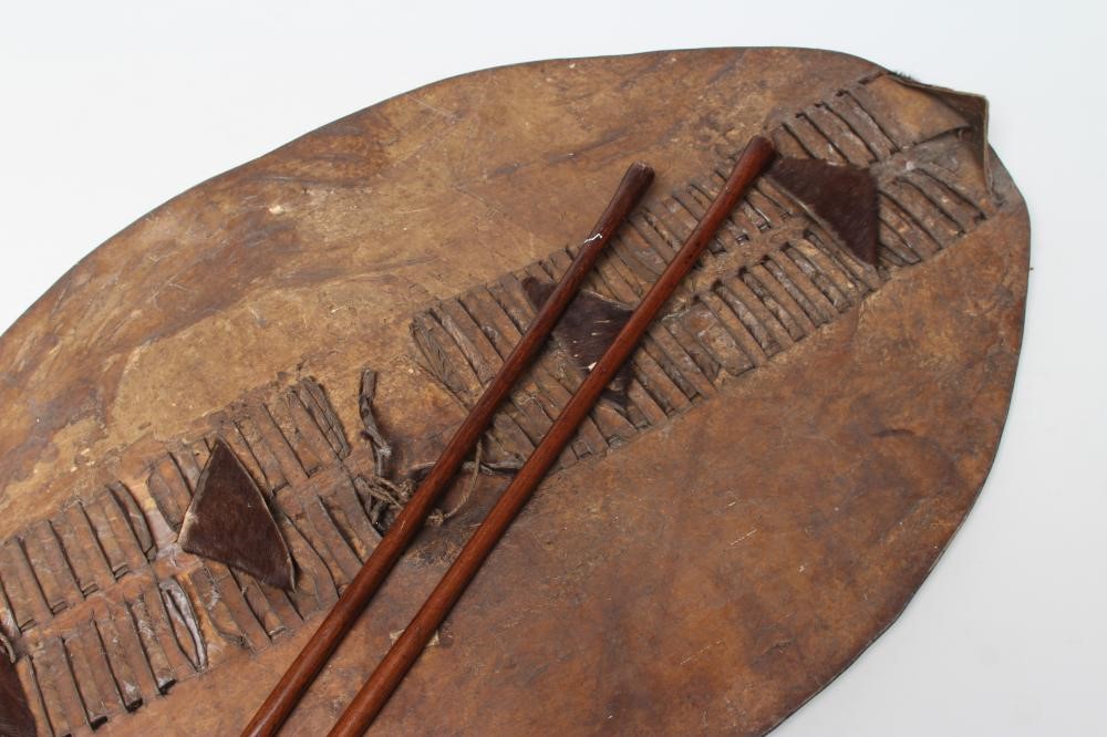 A ZULU COWHIDE SHIELD AND TWO ASSAGAI Image