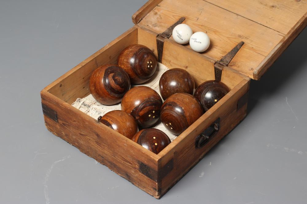 A SET OF EIGHT LIGNUM VITAE LAWN BOWLING BALLS together with a pair of Jacks Image