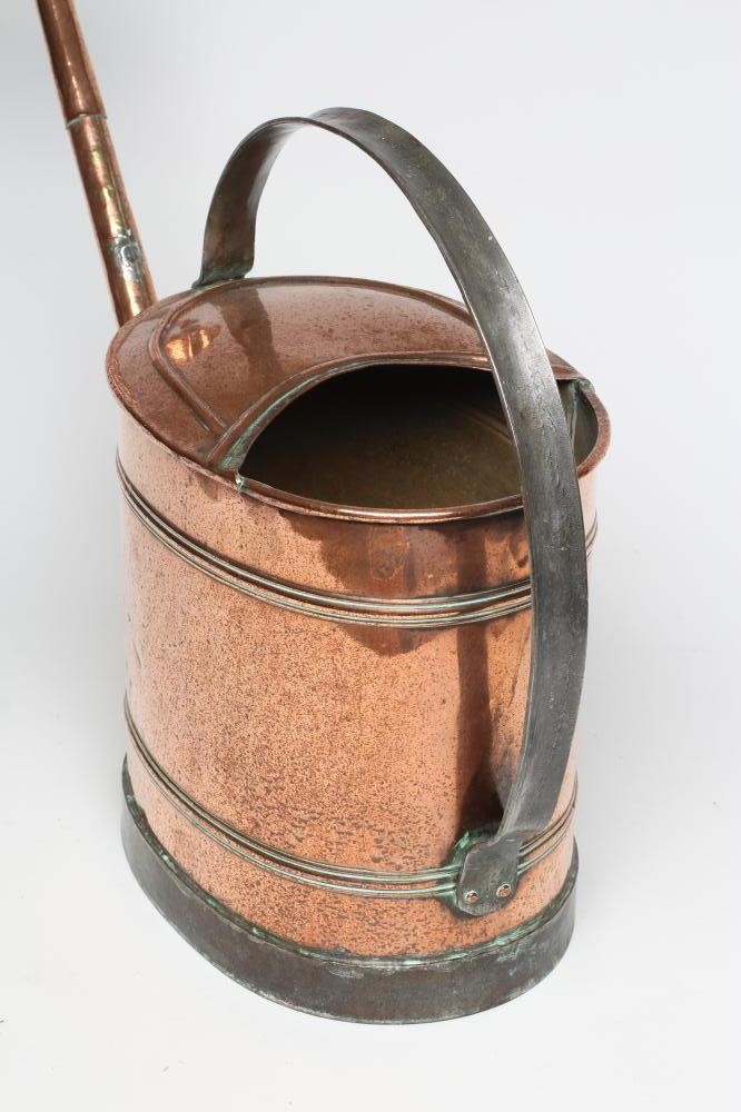 A LARGE COPPER WATERING CAN Image