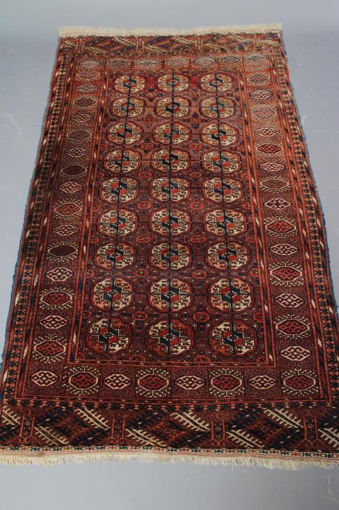 AN AFGHAN BOKHARA PATTERNED RUG Image