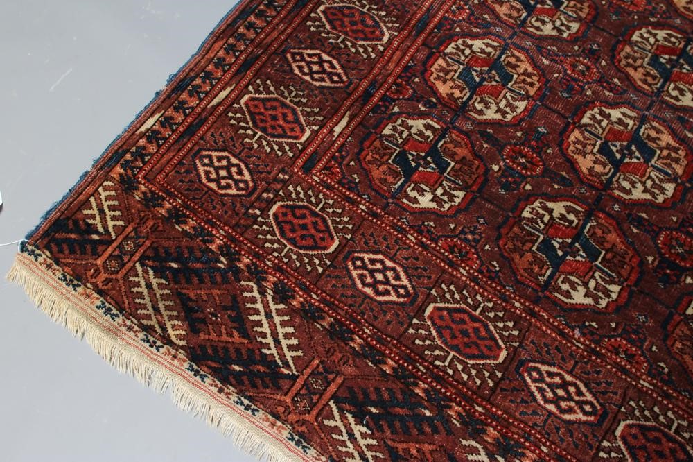 AN AFGHAN BOKHARA PATTERNED RUG Image