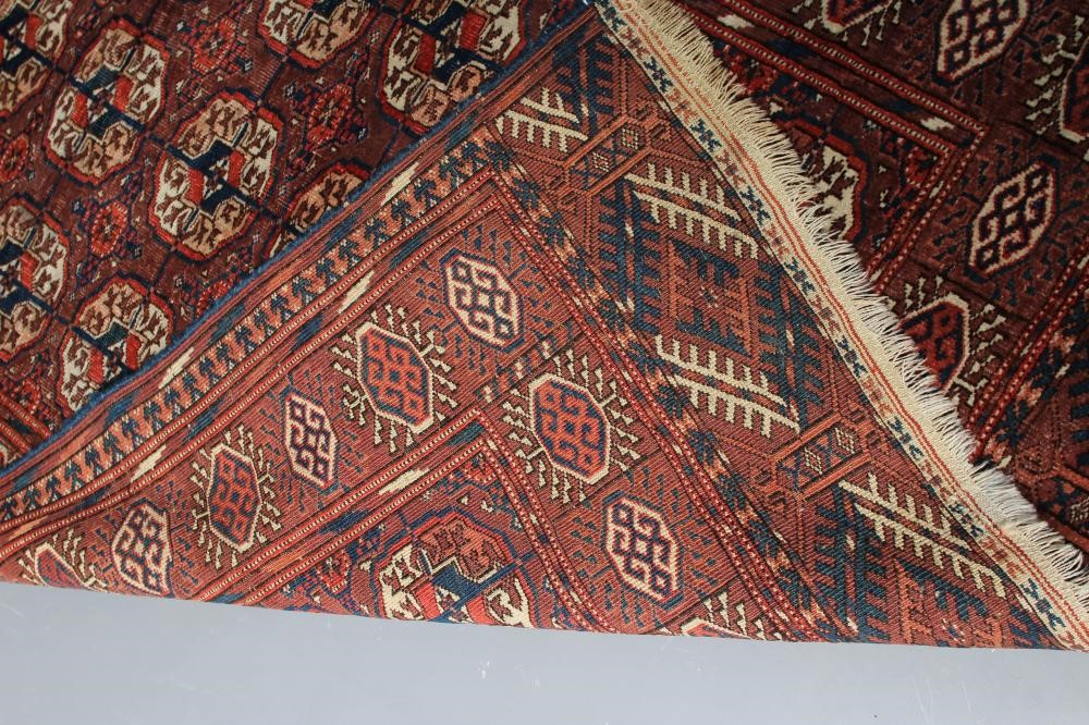 AN AFGHAN BOKHARA PATTERNED RUG Image