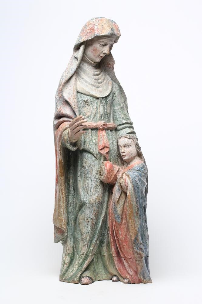 A CARVED WOOD AND POLYCHROME PAINTED FIGURE OF A FEMALE SAINT Image