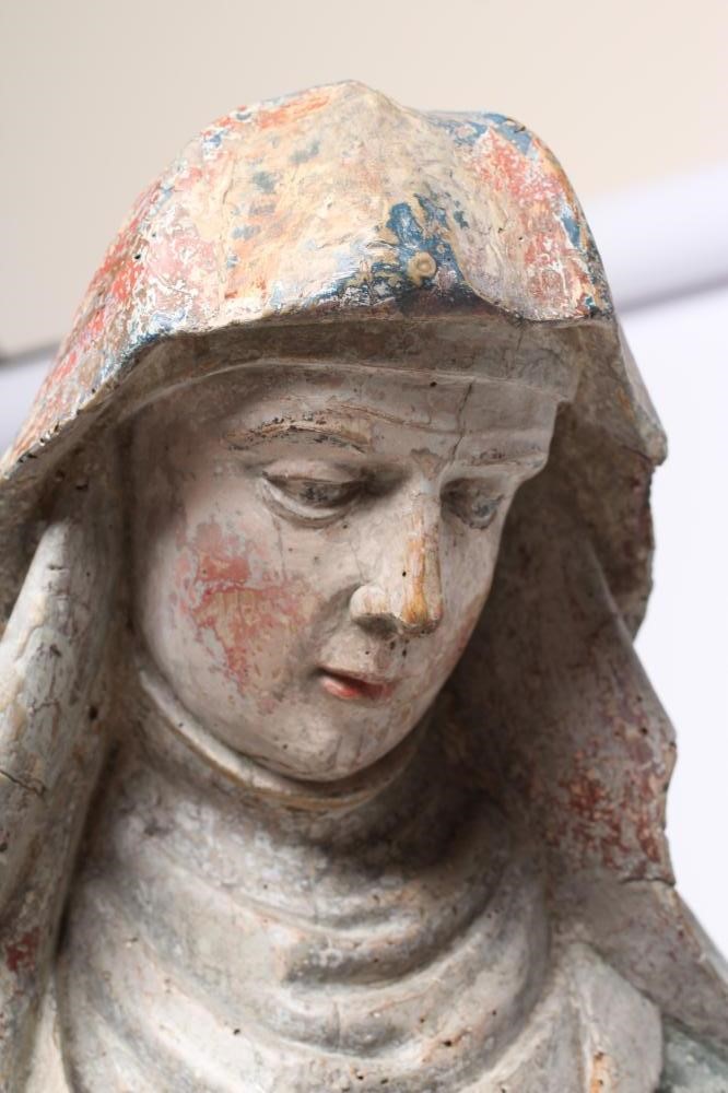 A CARVED WOOD AND POLYCHROME PAINTED FIGURE OF A FEMALE SAINT Image