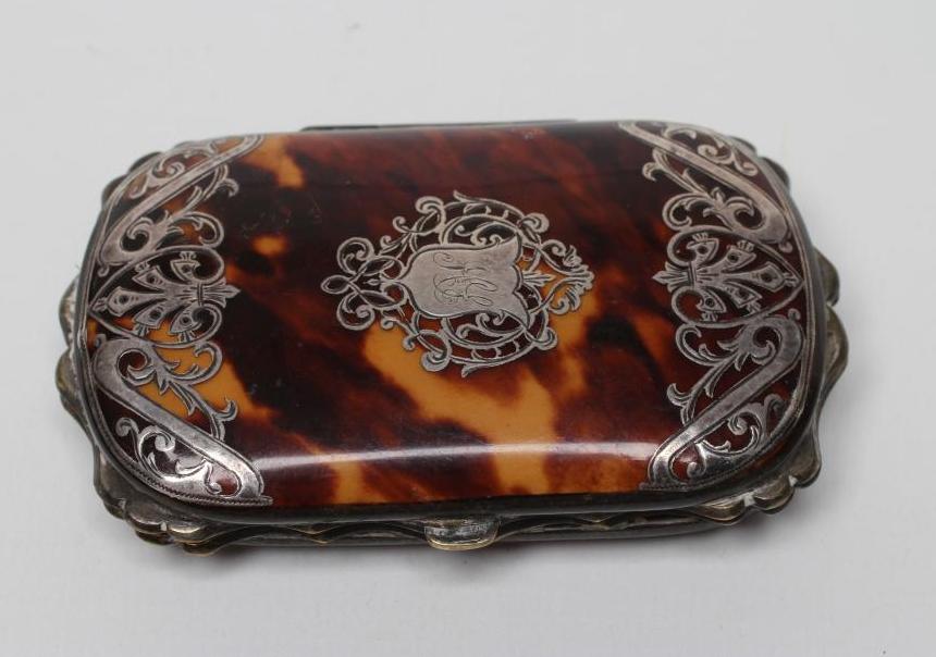 A VICTORIAN TORTOISESHELL PURSE of rounded oblong form with silver pique scroll work enclosing Image