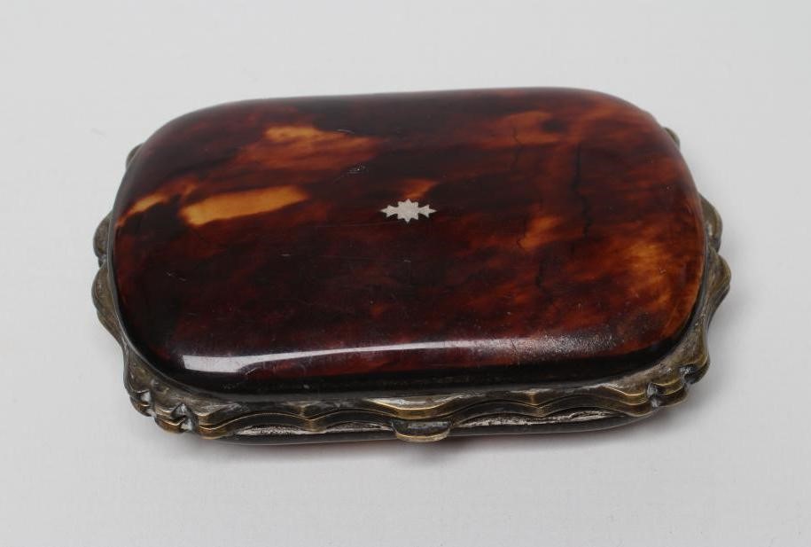 A VICTORIAN TORTOISESHELL PURSE of rounded oblong form with silver pique scroll work enclosing Image