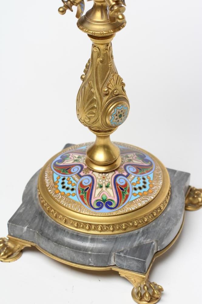 A GILDED BRASS AND GREY ONYX CHAMPLEVE ENAMEL CANDELABRUM Image