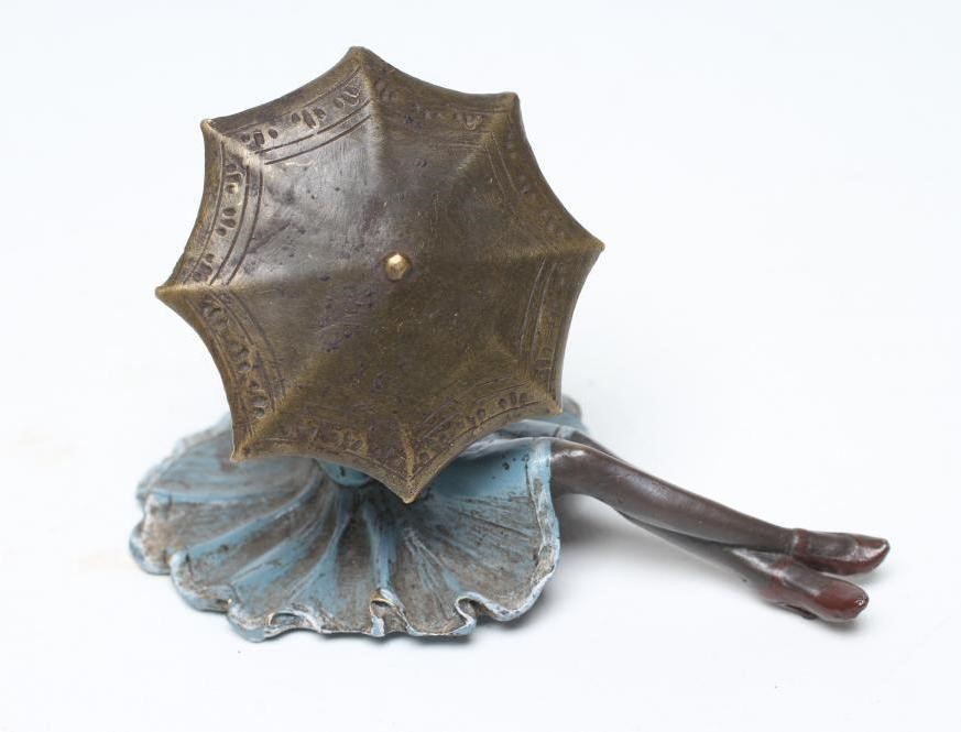 AN EROTIC BRONZE FIGURE modelled as a young lady in 1920's style blue enamelled dress and hat Image