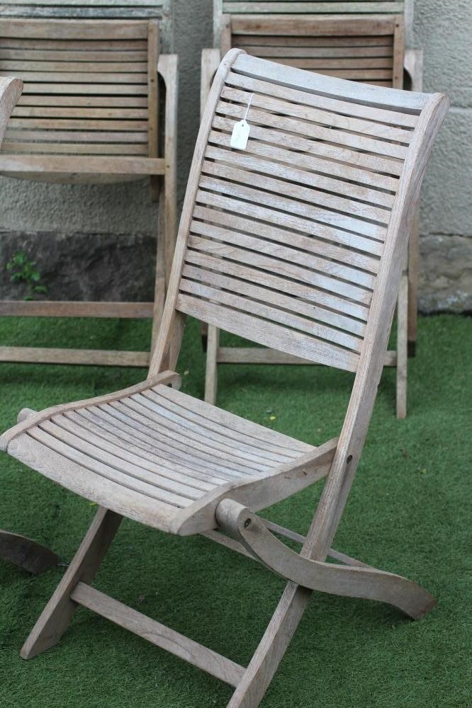 A SET OF FOUR TEAK FOLDING GARDEN CHAIRS with slatted seat and back on shaped square section Image