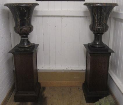 A PAIR OF VEINED BLACK MARBLE URNS Image