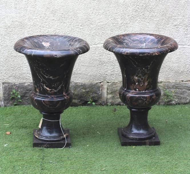 A PAIR OF VEINED BLACK MARBLE URNS Image