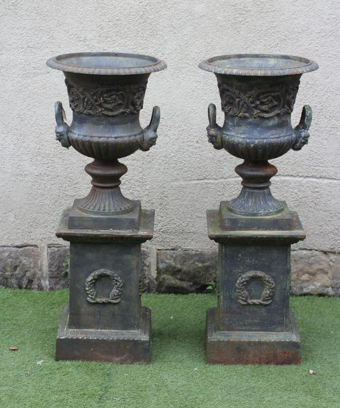 A PAIR OF CAST IRON URNS Image
