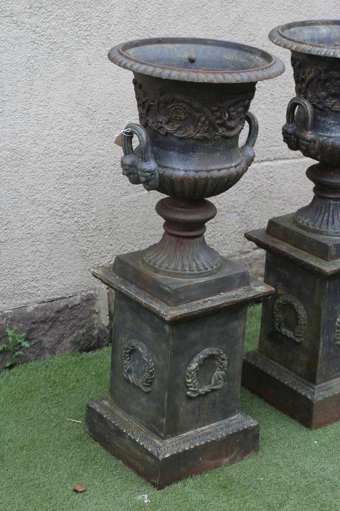 A PAIR OF CAST IRON URNS Image