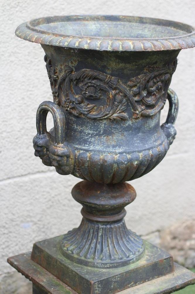 A PAIR OF CAST IRON URNS Image