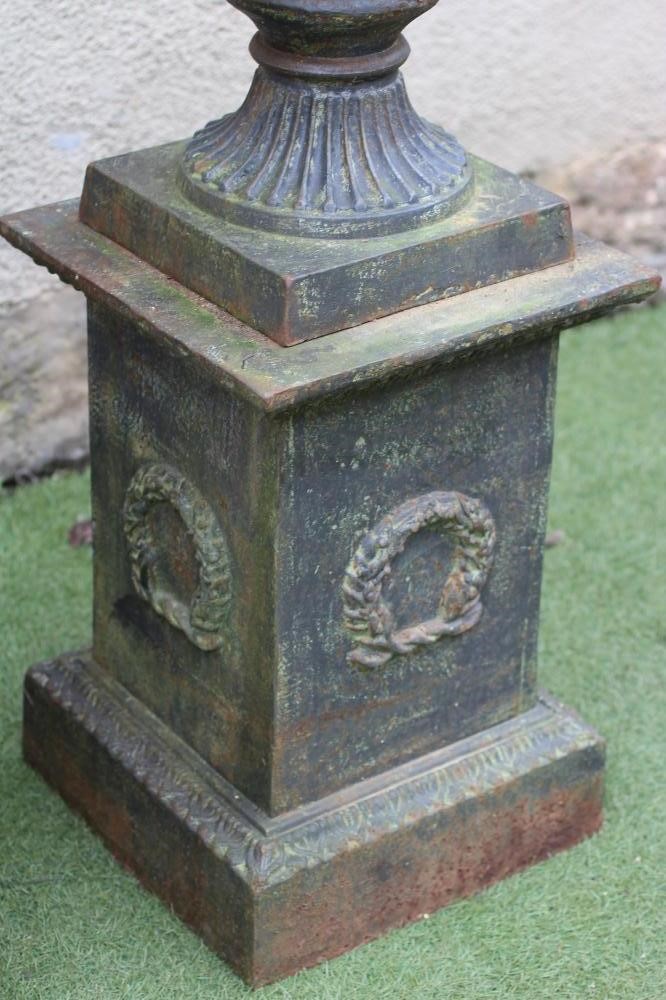 A PAIR OF CAST IRON URNS Image