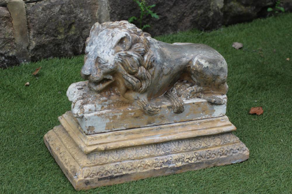 A STONEWARE FIGURE OF A RECUMBENT LION Image