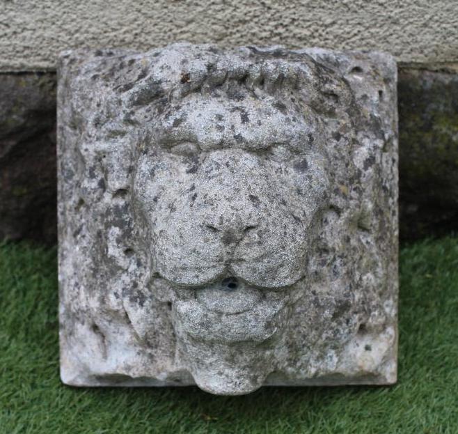 A CARVED STONE LION HEAD WALL FOUNTAIN Image