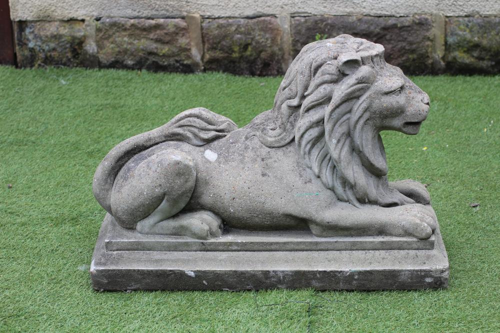 A COMPOSITE STONE RECUMBENT LION Image
