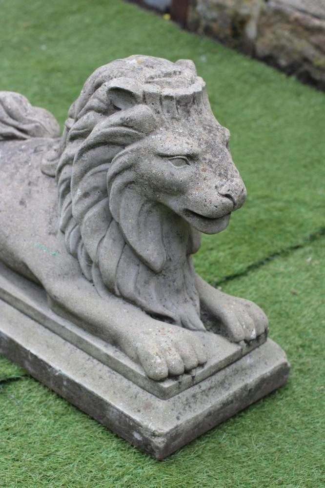 A COMPOSITE STONE RECUMBENT LION Image