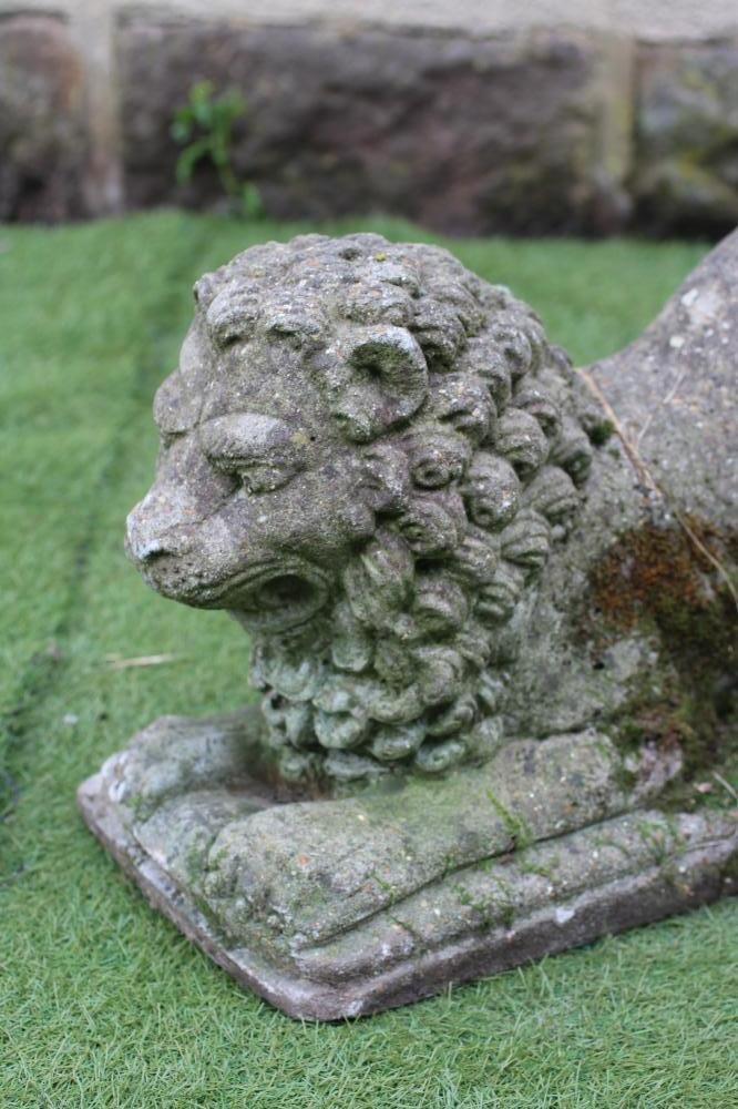 A PAIR OF COMPOSITE STONE LIONS COUCHANT Image