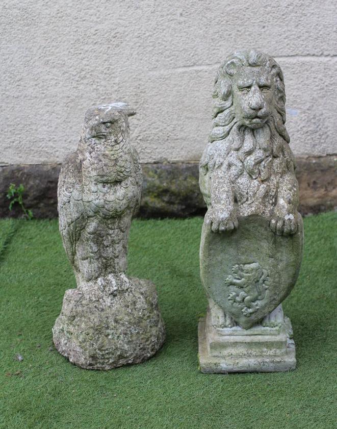 A COMPOSITE STONE FIGURE OF A LION SEJANT WITH SHIELD Image