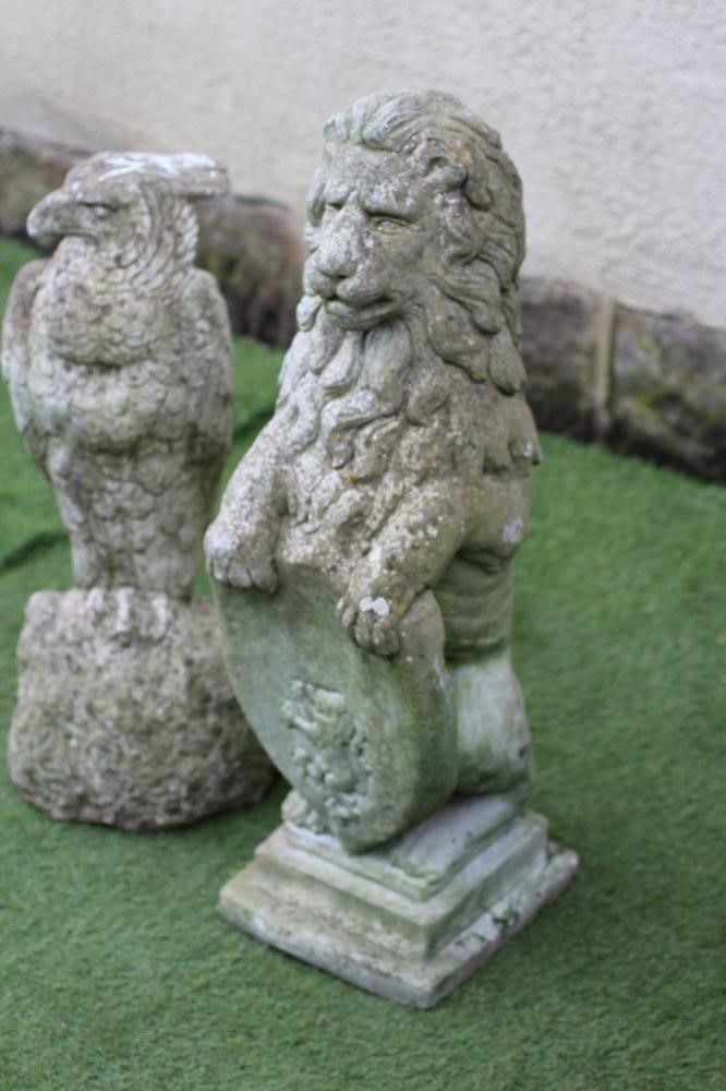 A COMPOSITE STONE FIGURE OF A LION SEJANT WITH SHIELD Image