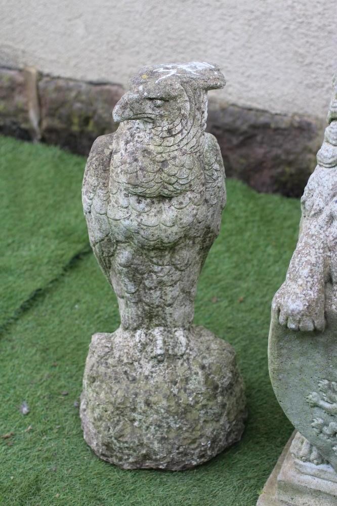 A COMPOSITE STONE FIGURE OF A LION SEJANT WITH SHIELD Image