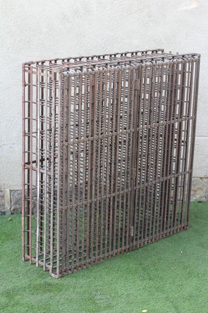 A WROUGHT AND CAST IRON WINE RACK Image