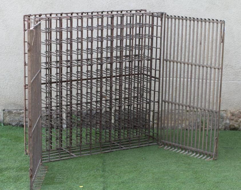 A WROUGHT AND CAST IRON WINE RACK Image