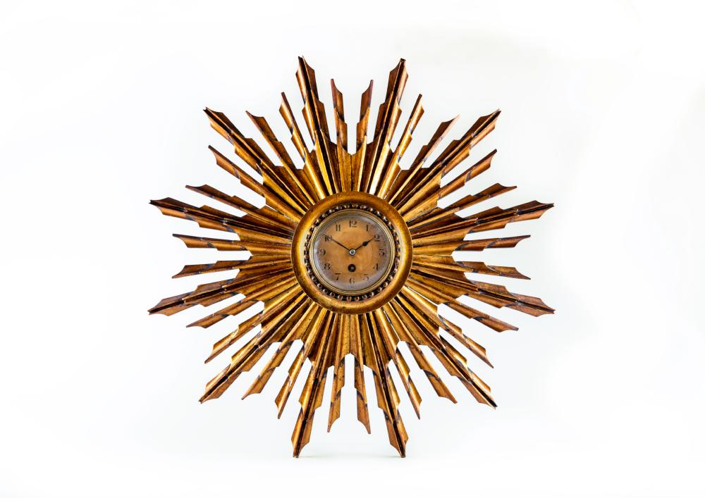 A FRENCH CARVED AND GILT WOOD SUNBURST WALL TIMEPIECE Image