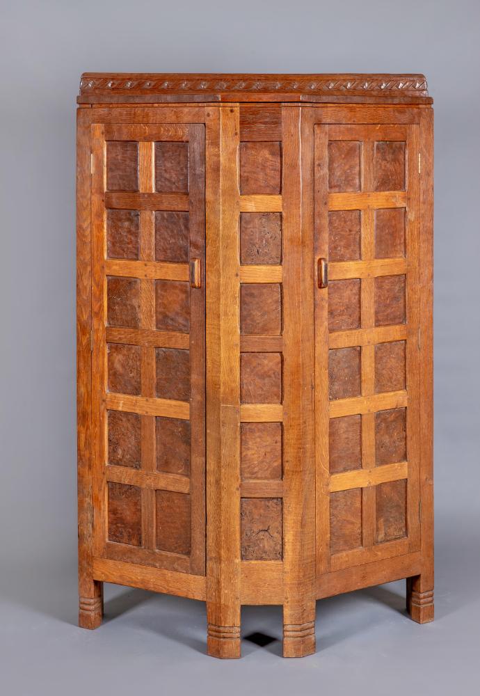 AN EARLY ROBERT THOMPSON ADZED OAK CUPBOARD Image