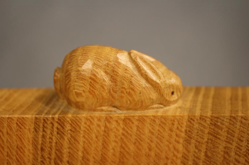 A PETER HEAP ADZED OAK BOOKCASE of shallow oblong form with a pair of glazed doors enclosing Image