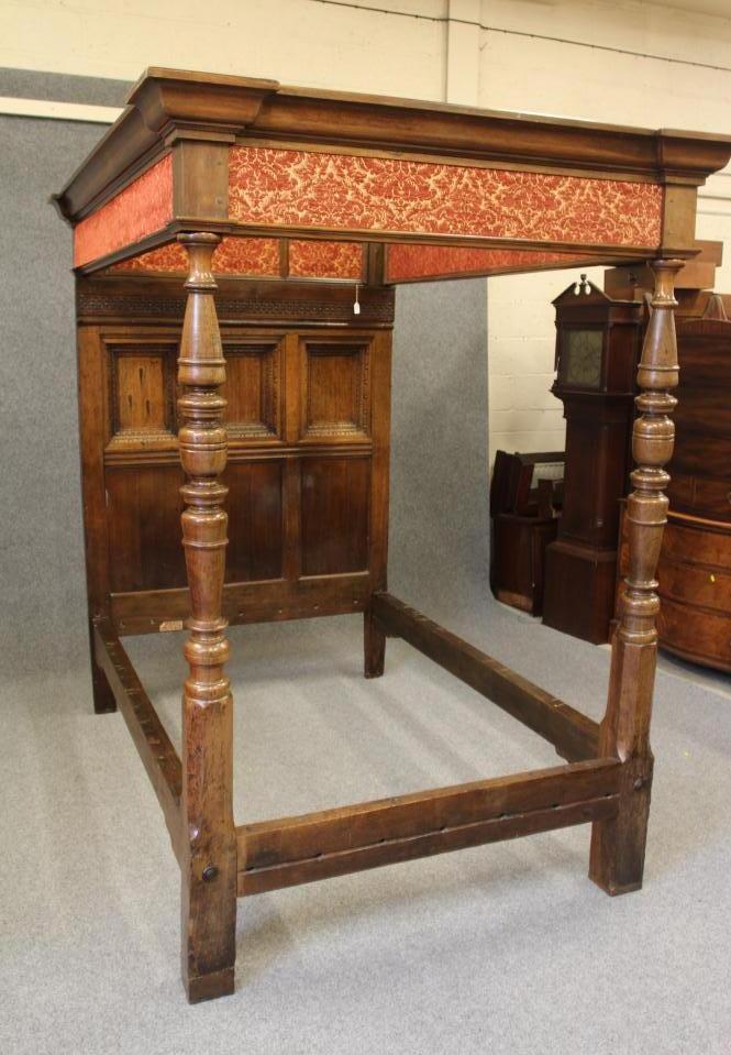 A CARVED AND JOINED OAK CANOPY BEDSTEAD Image