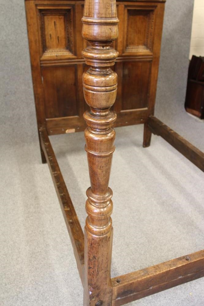A CARVED AND JOINED OAK CANOPY BEDSTEAD Image