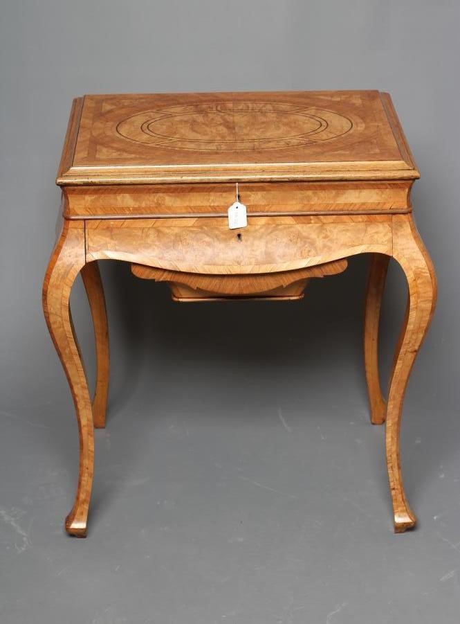 A FRENCH BURR WALNUT AND MAHOGANY BANDED WORK TABLE Image