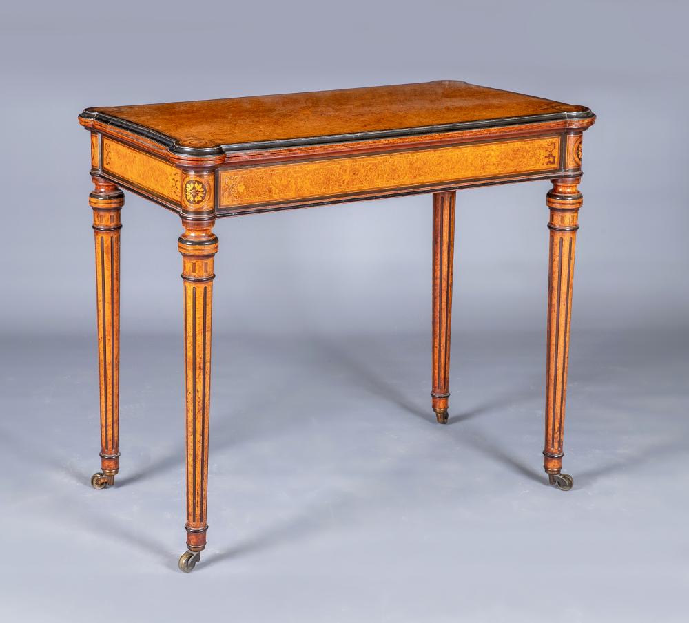 A FINE QUALITY AMBOYNA FOLDING CARD TABLE in the manner of Jackson & Graham Image