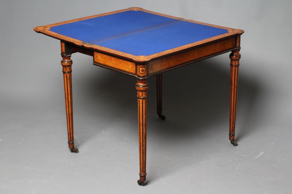A FINE QUALITY AMBOYNA FOLDING CARD TABLE in the manner of Jackson & Graham Image